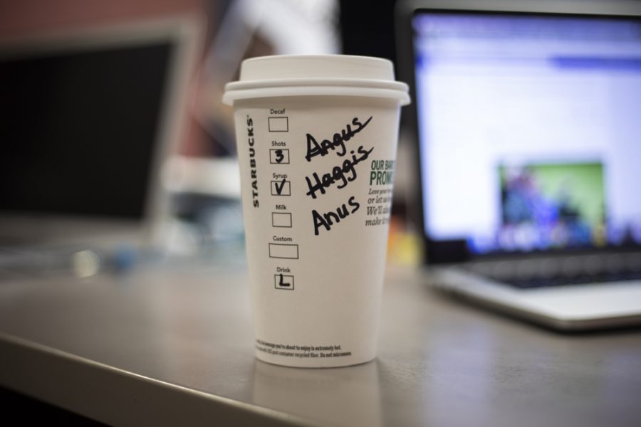 A Starbucks cup reads Angus, (crossed out) Haggis, (crossed out) and Anus.