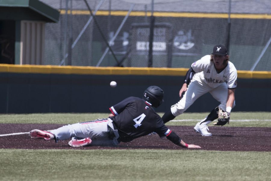 Wichita State's Alec Bohm catches a throw from catcher Gunnar Troutwine as a Cincinnati runner slides to third base.