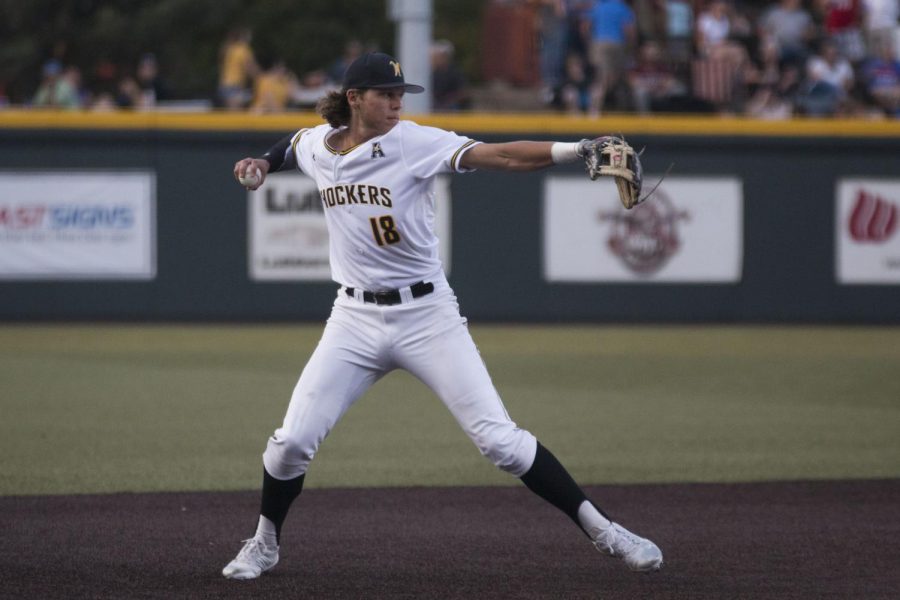 Wichita State junior Alec Bohm throws to first for an out against USF Friday evening at Eck Stadium. 