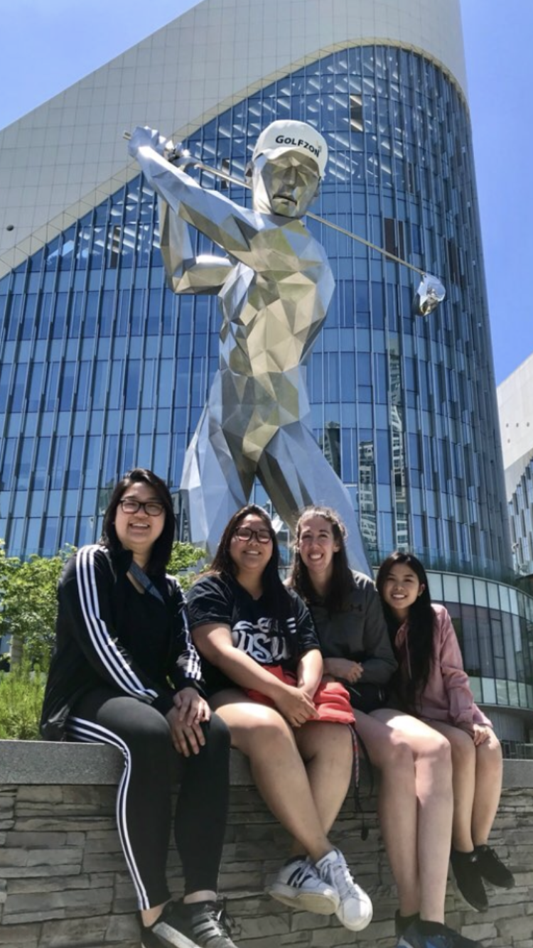 Wichita State students (left to right) Christina Cao, Theresa Doan, Lorryn McGuire, and Claudia Nguyen pose outside after after watching part of the Lotte Rent a Car Women's GolfZon Tour virtual professional golf tournament in Daejeon, South Korea.