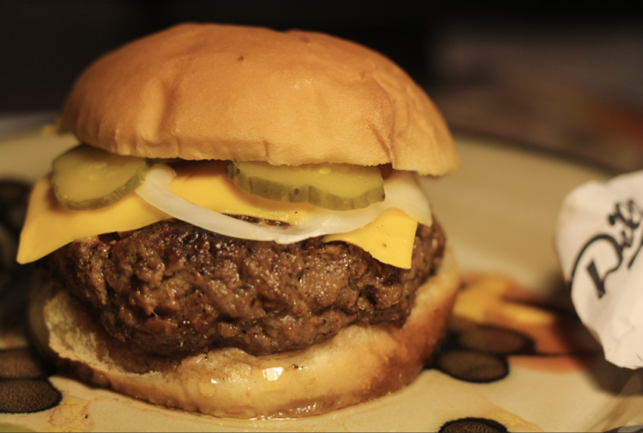 The hamburger is a truly continental dish that can be enjoyed cheaply, simply, and without complicated, convoluted ingredients. This variation consists simply of ground chuck, salt, pepper, garlic powder, onion powder, pickles, American cheese, and a ring of white onion.