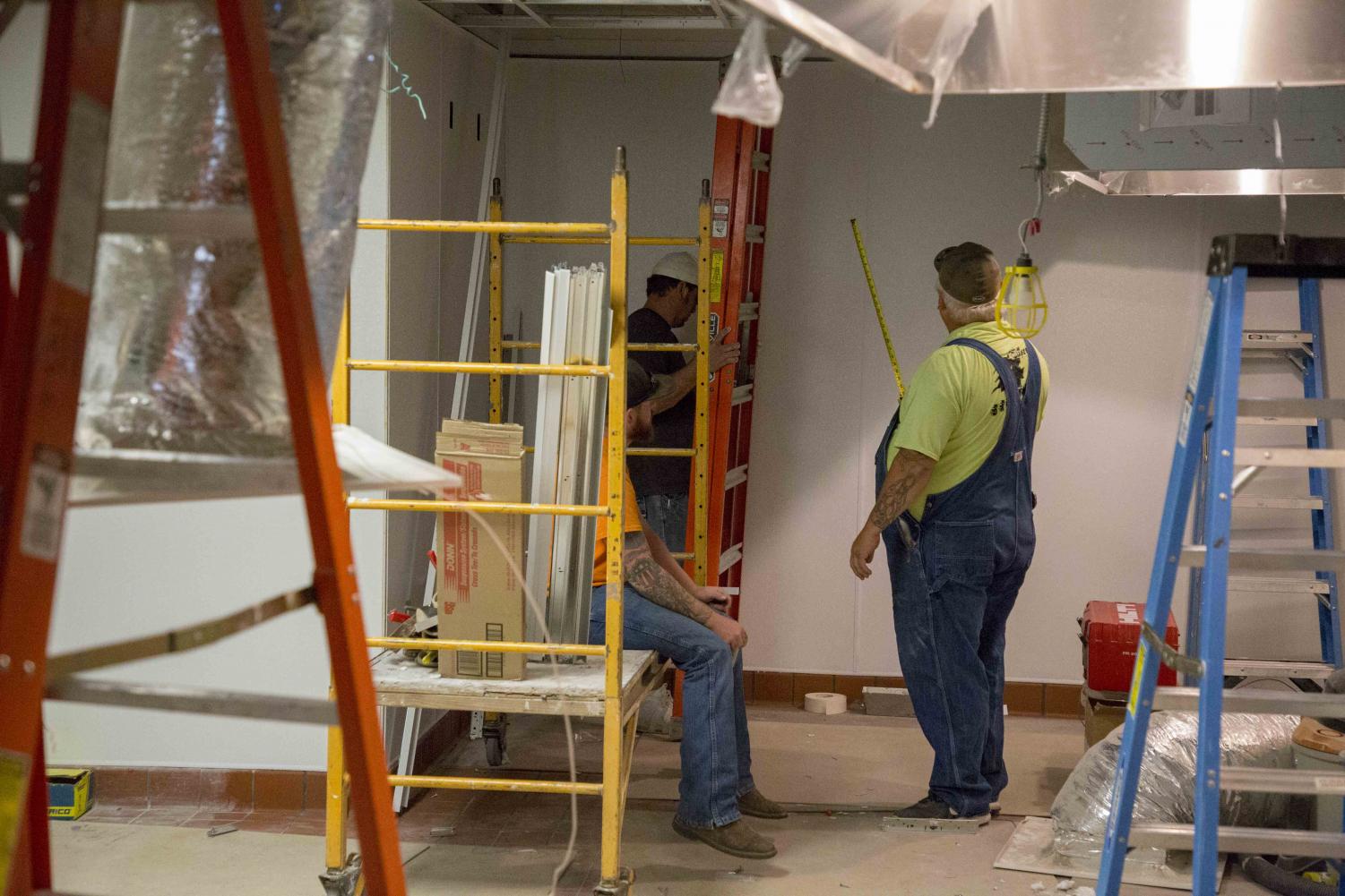 Contract workers work on transforming the former space of Mondo Subs to Freddy's Frozen Custard and Steakburgers. Freddy's is expected to open the first day of the fall semester, Aug. 20.