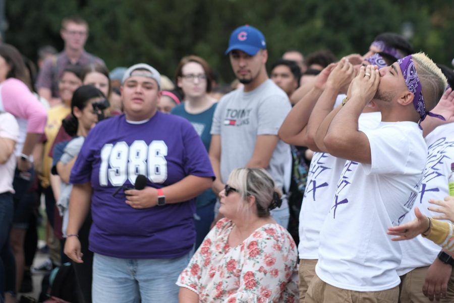 Sigma Lambda Beta Fraternity yell out to show their energy before the performance.