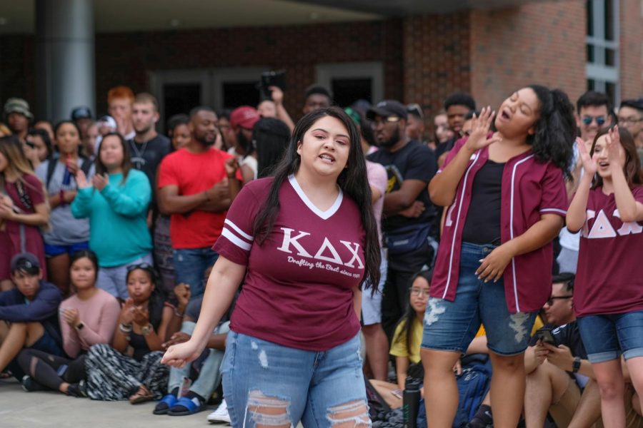 Savana Servantez explains the history of Kappa Delta Chi Sorority to students.