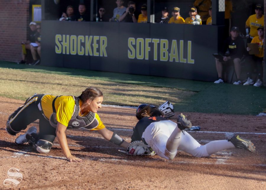 Wichita State catcher Madison Perrigan tags out an Oklahoma State runner at home plate. Wichita State lost to Oklahoma State on the game held Sept. 27, 2018 at Wilkins Stadium.