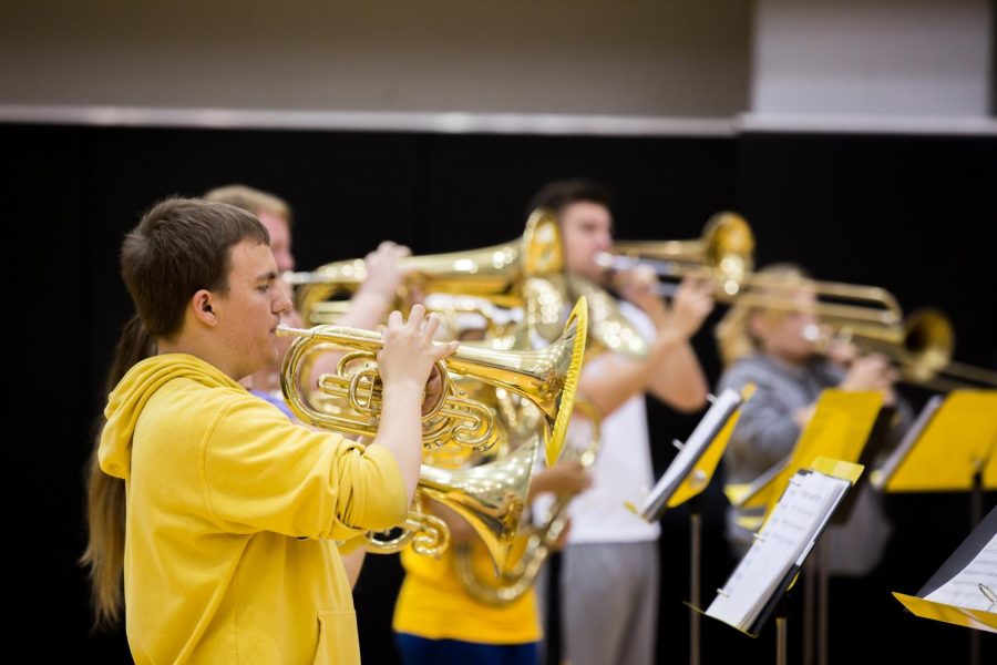 Members of the Wichita State Marching Band play their instruments during practice held in Koch Arena. 