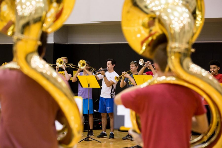 Members of the Wichita State Marching Band play their instruments during practice held in Koch Arena. 