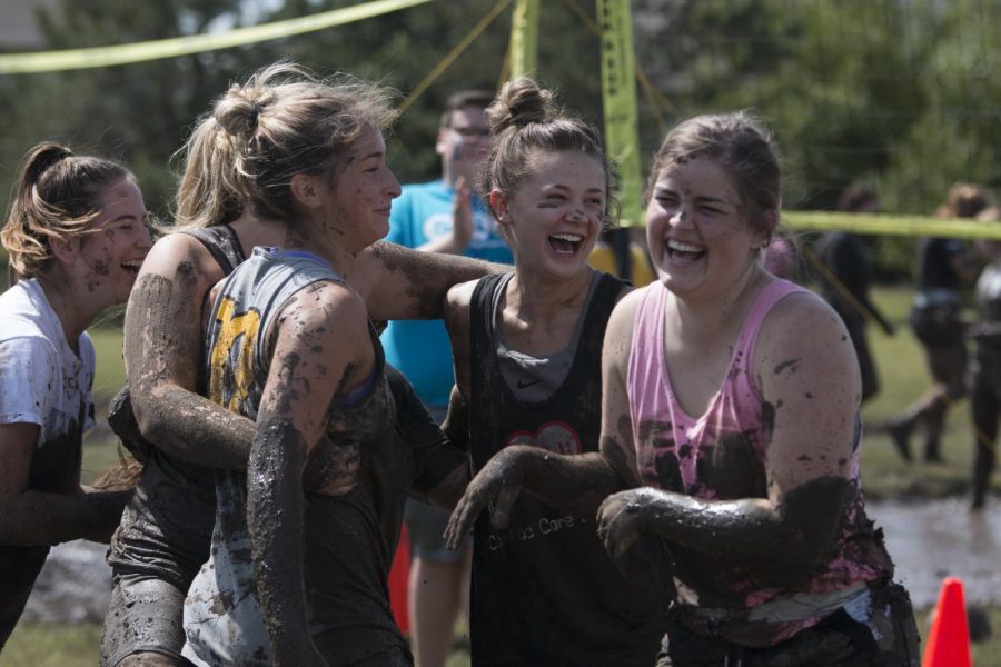 Members of the Alpha Phi team celebrate after winning a round of the mud volleyball tournament. 