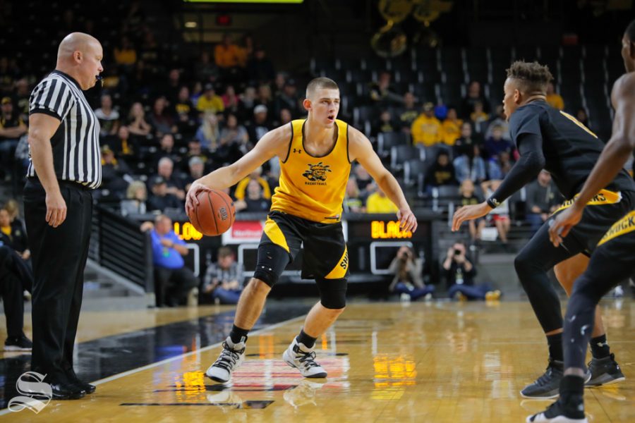 Wichita States Erik Stevenson dribbles around Dexter Dennis during the Black and Yellow Scrimmage at Koch Arena on Oct. 6, 2018.