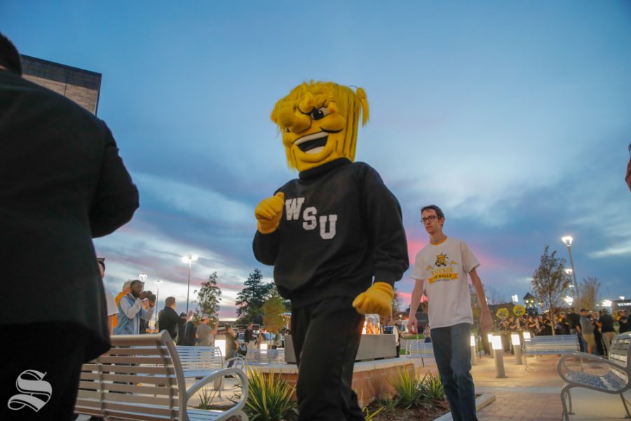 Wu+Shock+walks+into+the+pep+rally+with+the+Shocker+Marching+Band+at+the+pep+rally+on+Monday.+%28Joseph+Barringhaus%2FThe+Sunflower%29