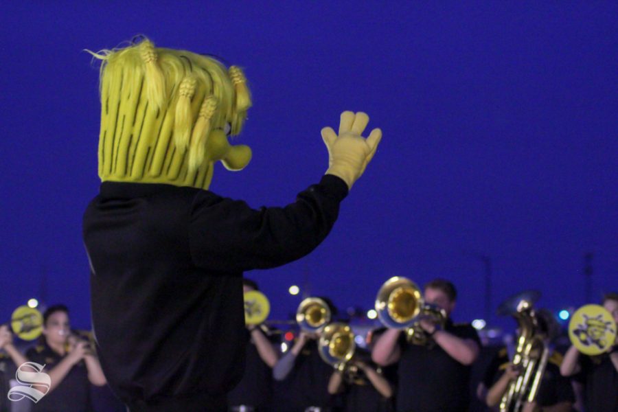 Wu Shock conducts the Shocker Sound band at the pep rally. (Kylie Cameron/The Sunflower)
