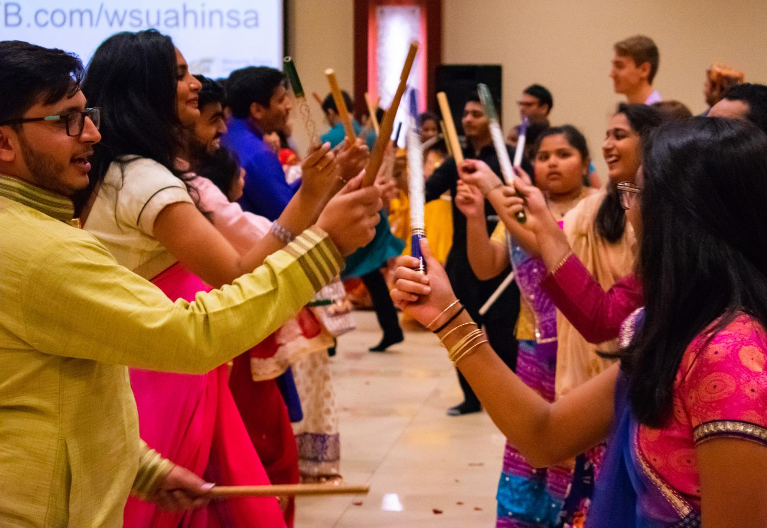 Garba Night 2018 attendees perform the Dandiya Raas dance at Garba Night 2018. The event was held by AHINSA on the third floor of the RSC Saturday, Oct. 13, 2018.