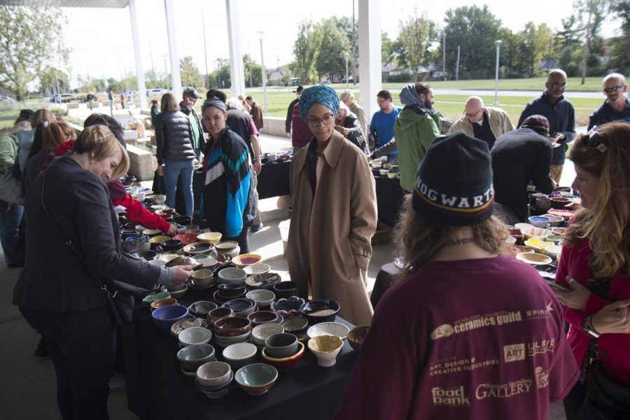 Members of the Wichita community pick out handmade bowls to buy during the Empty Bowls Chili Cook-Off event.