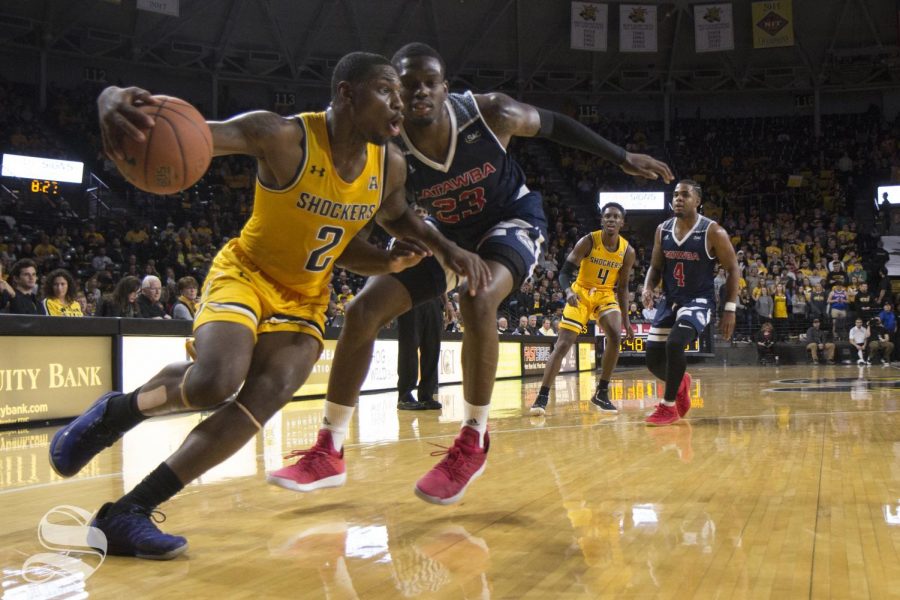 Wichita States Jamarius Burton drives past a Catawba defender during the exhibition match Tuesday evening at Koch Arena.