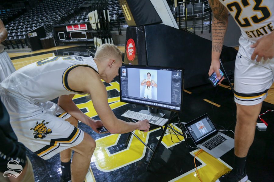 Brycen Bush scrolls through photos from media day at Koch Arena.