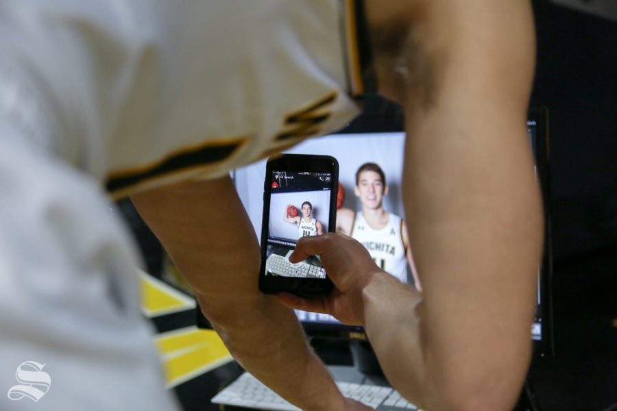 Jacob Herrs takes a snapchat of photos from media day at Koch Arena.