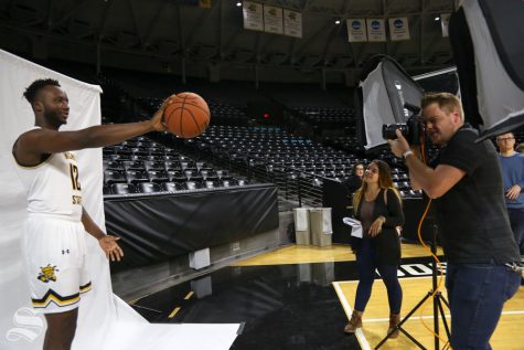 The Sunflower's Joseph Barringhaus photographs Morris Udeze during media day at Koch Arena in 2018.