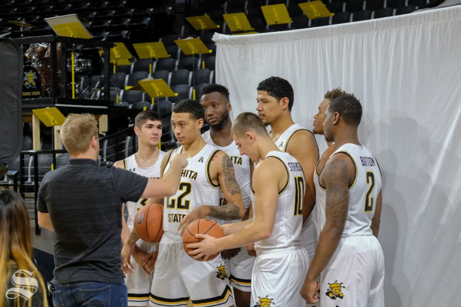 Joseph Barringhuas, Sports Photo Editor of the Sunflower, instructs the players on how to pose for the photos.