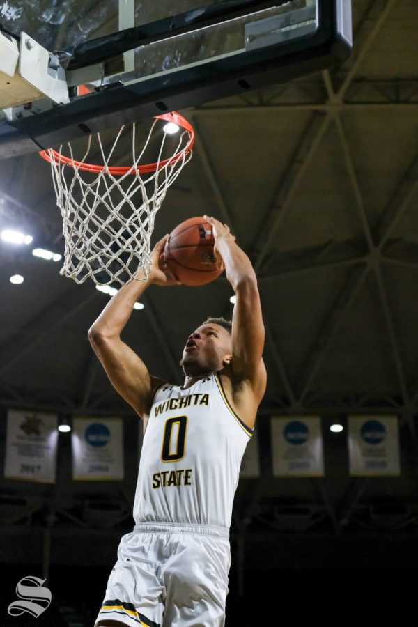 Wichita State guard Dexter Dennis dunks the ball during a break at media day on Oct. 16, 2018.