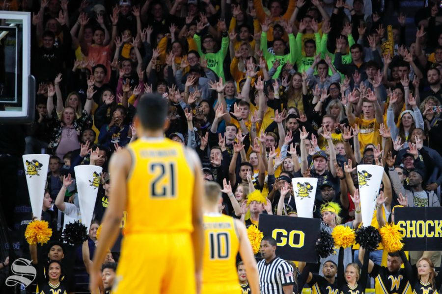 Wichita+States+student+section+raises+their+hands+during+the+basketball+game+on+Oct.+30%2C+2018+in+Koch+Arena.