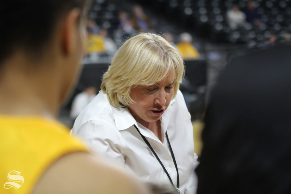 Womens basketball coach Keitha Adams instructs players at the beginning of halftime.