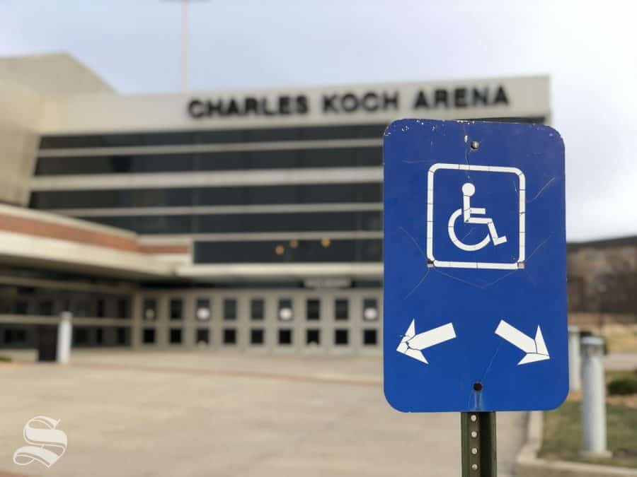Fans who typically use disability parking spots outside of Charles Koch Arena had to choose to either pay $10 to park their vehicle or walk in the cold, wintery rain Saturday night. 