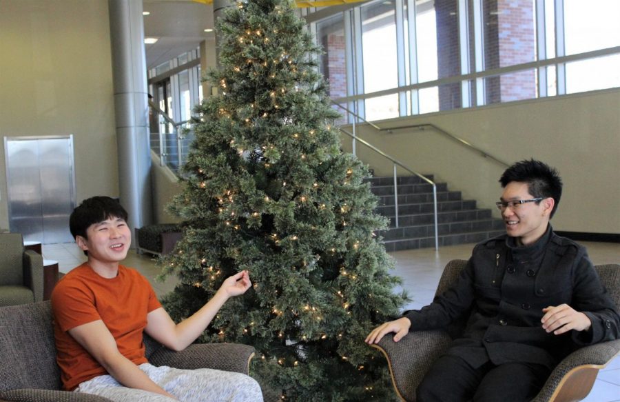 Malaysian international students Jerome Jun Chang Teoh (left) and Christopher Mong En Leong (right) sit in the Rhatigan Student Center. Both are staying on campus over the holidays.