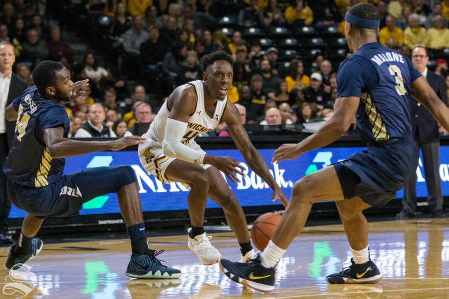 Wichita State senior Samajae Haynes-Jones attempts to drive past Oral Roberts defenders during the game at Koch Arena Wednesday, Dec. 19, 2018.