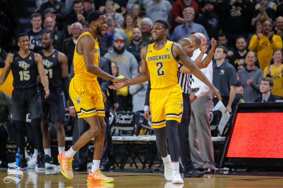 Wichita State freshman Jamarius Burton cheers with senior Markis McDuffie after drawing a foul towards the end of the first half. WSU played UCF on Jan. 16, 2019 at Charles Koch Arena.