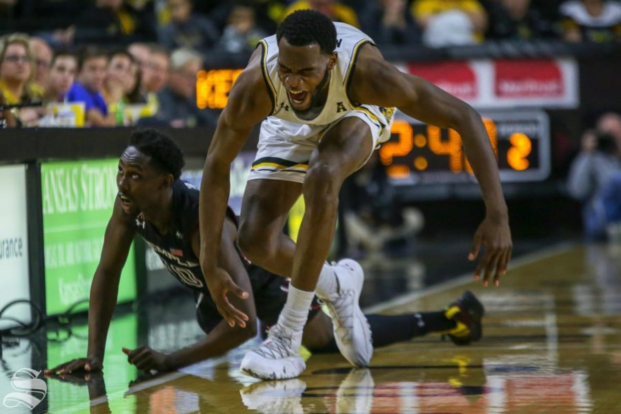 Wichita State senior Markis McDuffie is tripped up by Temple's Shizz Alston, Jr. in the second half of Sunday's game. Temple won the game in overtime. 