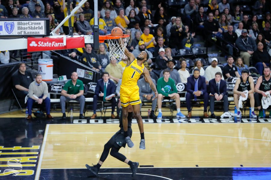 Wichita+State+forward+Markis+McDuffie+slams+it+down+over+a+Tulane+defender+in+the+first+half+of+the+game+against+Tulane+on+Feb.+9%2C+2019+at+Charles+Koch+Arena.+%28Photo+by+Joseph+Barringhaus%2FThe+Sunflower%29.