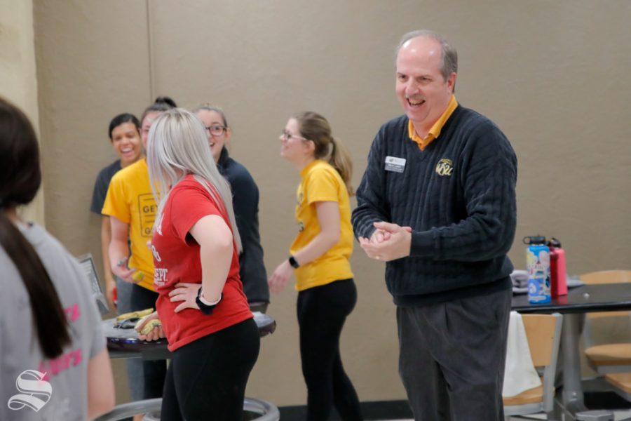 Mark Lewis laughs with a players of the womens bowling team on Feb. 12, 2019 at the Rhatigan Student Center.