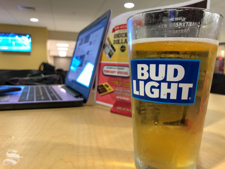 A student enjoys a beer in the Rhatigan Student Center on Feb. 13, 2019. Beer and other adult beverages are available for purchase at Charles Koch Arena, Wilkins Stadium, and Eck Stadium but outside beverages will not be allowed.