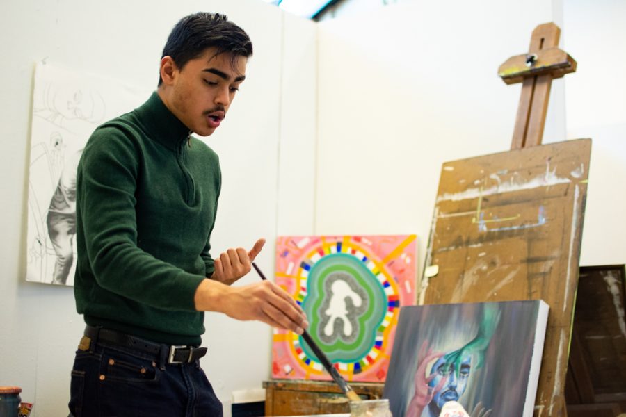 Emiliano Molina responds to questions during an interview with The Sunflower while he begins the process of painting two new pieces.