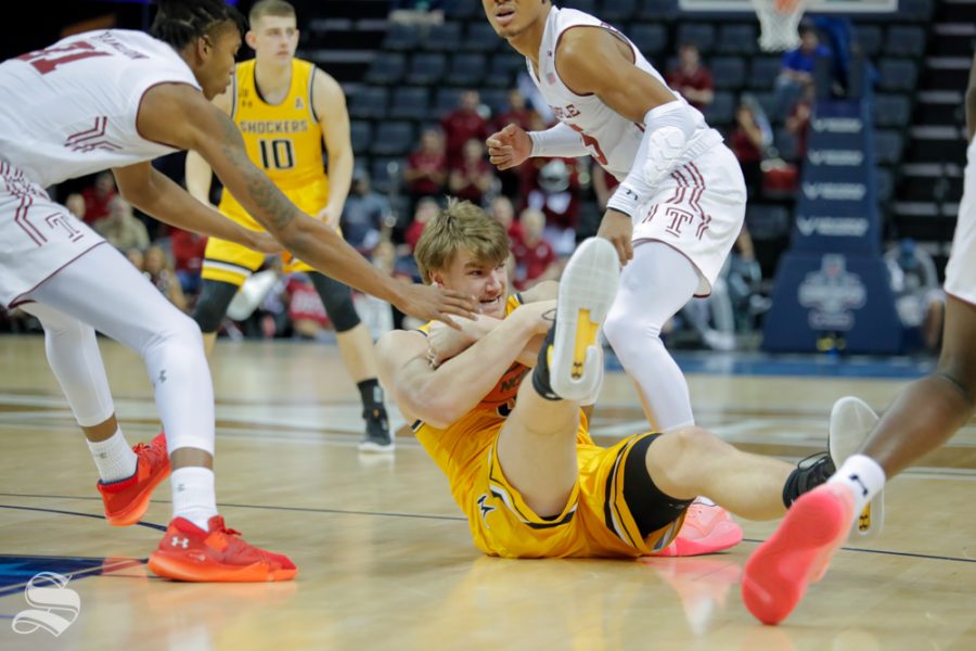 Wichita State forward Asbjørn Midtgaard fights for the ball on the ground during the second half of the game against Temple on March 15, 2019 at the FedExForum in Memphis, Tennessee. (Photo by Joseph Barringhaus/The Sunflower).