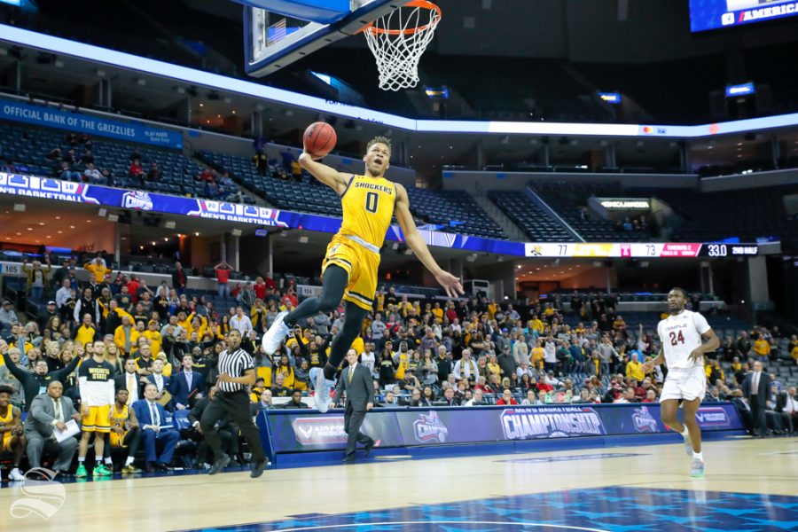 Wichita State guard Dexter Dennis receives a pass from guard Erik Stevenson and finishes the dunk with 33 seconds left in the second half. Stevenson threw the homerun pass to beat Temples full-court pressure. The Shockers were up 77-73 at this point in the game. (Photo by Joseph Barringhaus/The Sunflower).