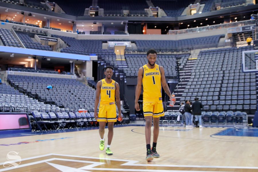 Wichita State seniors Markis McDuffie and Samajae Haynes-Jones walk back from the press conference. McDuffie and Haynes-Jones took a moment to take photos with fans before walking across the court in Memphis for the last time. (Photo by Joseph Barringhaus/The Sunflower).