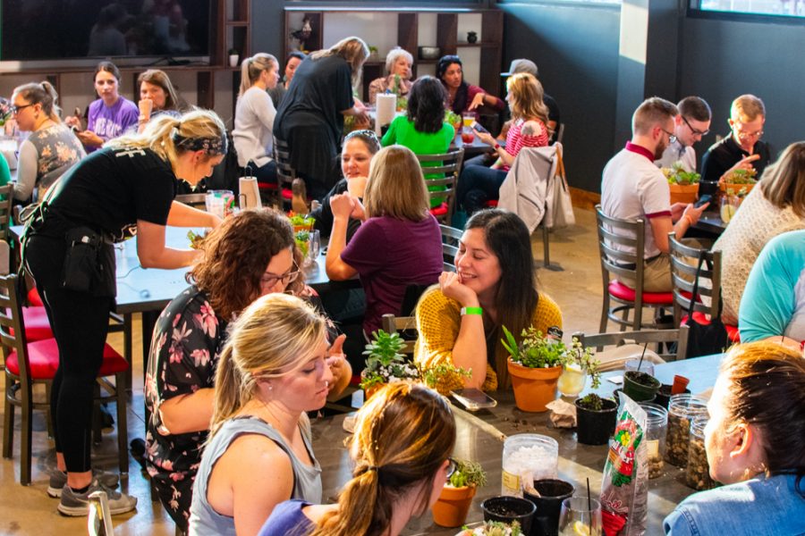 Wichita State graphic design student, Madison Zorn, waits the tables during the Succulents & Sangria event at Chicken N Pickle on Wednesday, March 27, 2019.