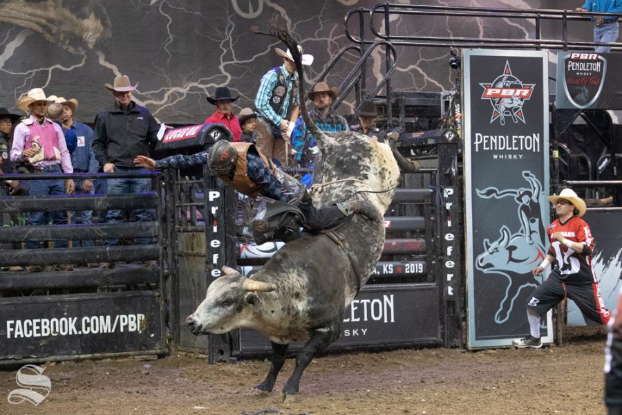 Brian Ferguson holds onto Good Night Robicheaux for 2.62 seconds during the first round of the PBR Pendleton Whisky Velocity Tour on April 13, 2019 at INTRUST Bank Arena. (Photo by Joseph Barringhaus/The Sunflower).