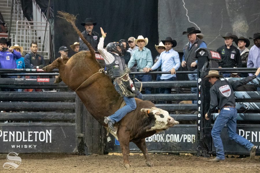 Ueberson Duarte holds onto Fire & Smoke for 5.77 seconds during the second round of the PBR Pendleton Whisky Velocity Tour on April 13, 2019 at INTRUST Bank Arena. (Photo by Joseph Barringhaus/The Sunflower).