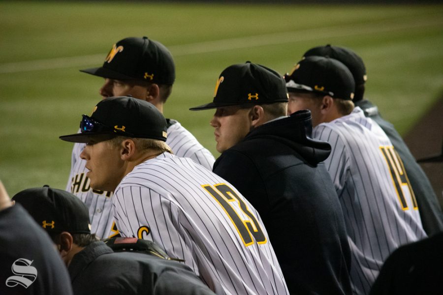 Wichita State players watch and wait for the decision to postpone the game in the seventh inning of their game against University of Central Florida on Friday, April 19. (Photos by Easton Thompson / The Sunflower).