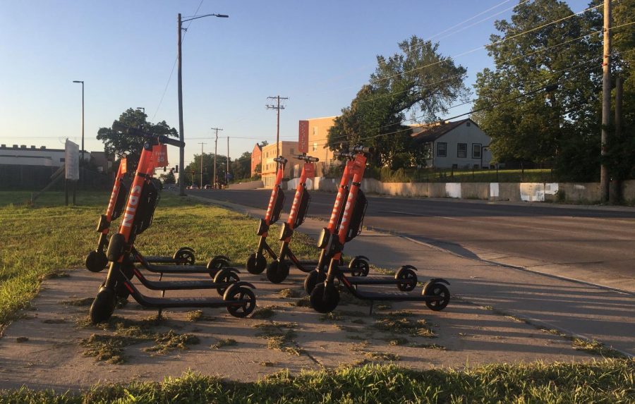 A fleet of e-scooters sit in an empty lot at 17th and Hillside near Wichita States main campus. E-scooters are currently not allowed on campus.