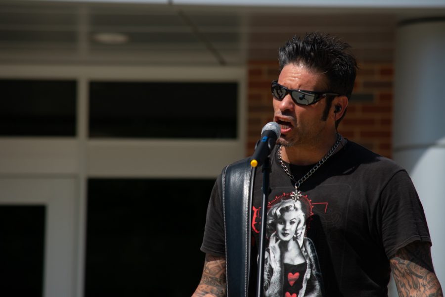 Annie Ups Rick Lopez sings a cover with other band members during the kick-off concert outside of the Rhatigan Student Center on Aug. 19.