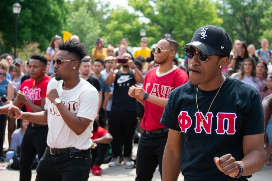 Phi Nu Pi members step in unison with Kappa Alpha psi Jalen Allen and Brandon Foreman during the MGC Yard Step event on Aug. 29 outside of the Rhatigan Student Center on Wichita States main campus.