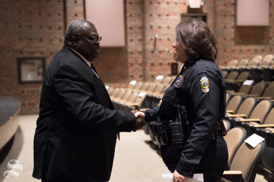 Director of Military and Veteran Services, Lt. Col. Larry Burks, greets Wichita Police Department Deputy Chief Anna Hatter before the  9 /11 Memorial Observance. Wichita State hosted the event at the CAC Theater.