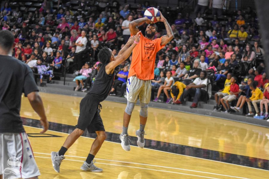 Kaelon Gary goes up for a three-point shot during the Hoops 4 Literacy game that was hosted by StoryTime Village and Wichita State on Friday inside Charles Koch Arena. The event hosted 1,200 local third graders.