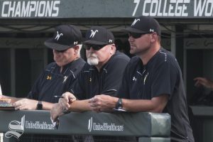 Members of the Wichita State coaching staff stand in the dugout Saturday.