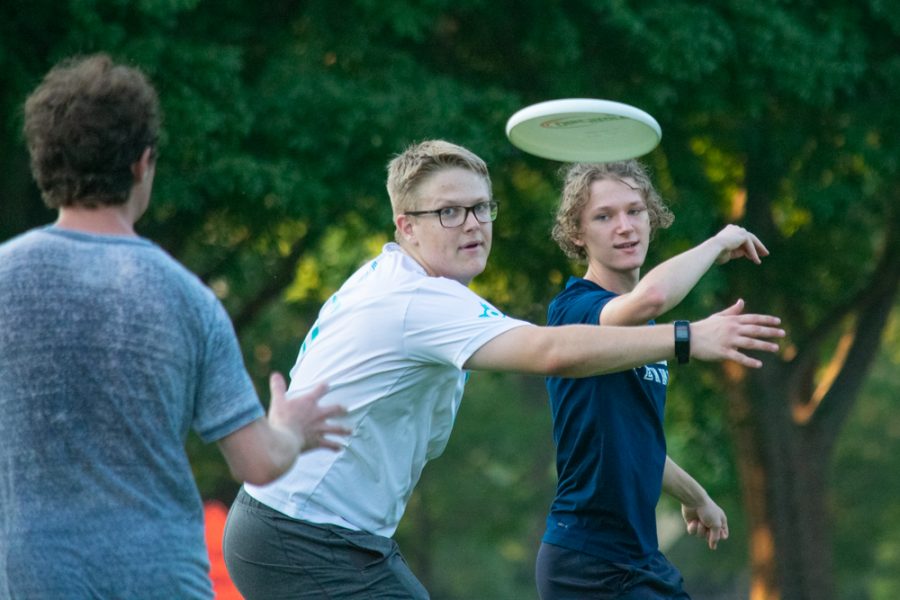 Captain John Mercer looks for the disk that captain David Jochems passes through his guard to a teammate during a Wichita State University Ultimate Frisbee Club practice on Sept. 3 at Fairmount Park. This practice was the first of the year for the club.