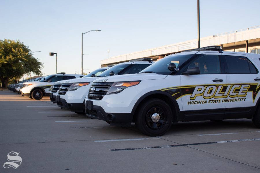A line of Wichita State University Police Department patrol cars line departments parking lot off Perimeter Road. 