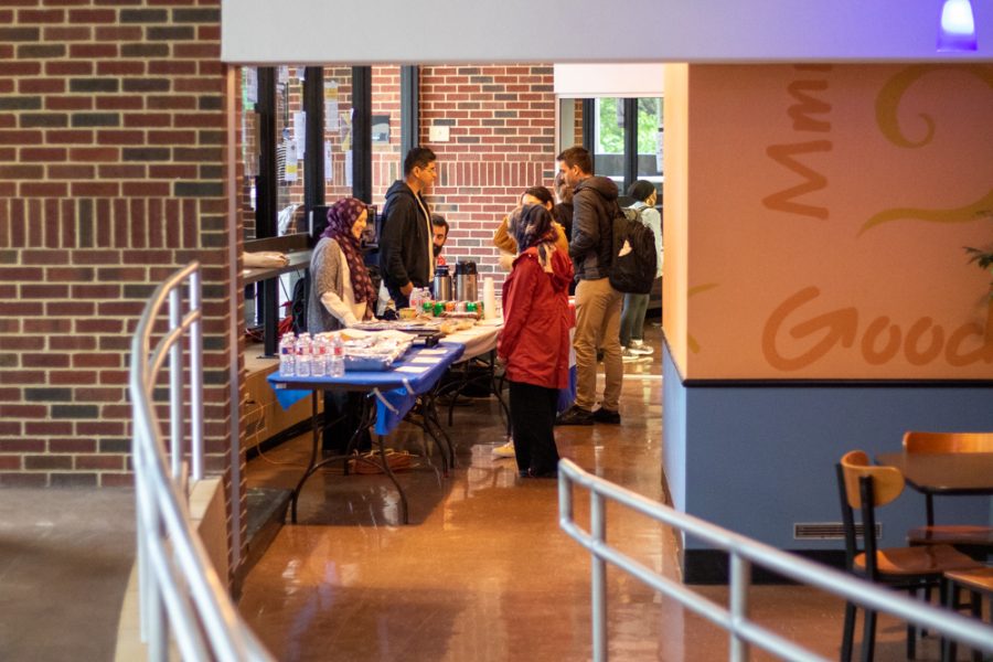 Students check the food options at one of the Interfest event tables on Oct. 3 at Hubbard Hall. The event was moved to Hubbard Hall from the Multicultural Greek Council Quad due to weather.